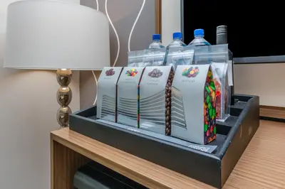 a table with two bottles of water and some books at FB Miami Beach Tresor Private Luxury Suites in Miami Beach
