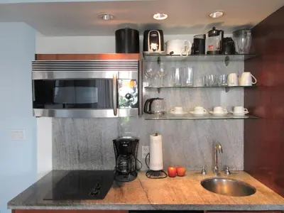 a kitchen with a sink and a microwave at VERSACE MANSION VIEW SUITE at THE STRAND in Miami Beach