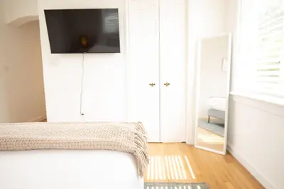 a bedroom with a bed with a tv and a mirror at Casa Coral in Miami