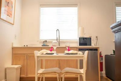 a kitchen with a table with two wine glasses on it at Casa Coral in Miami