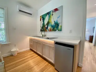 a kitchen with a sink and a painting on the wall at Casa Coral in Miami
