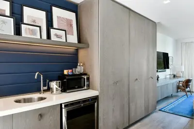 a kitchen with a sink and a microwave at Kaskades Hotel South Beach in Miami Beach