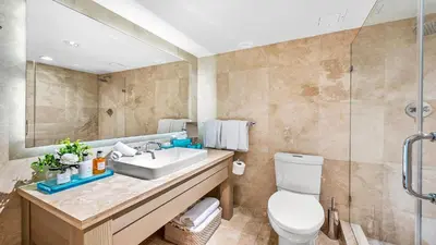 a bathroom with a sink and a toilet and a mirror at Oceanview Private Condo at 1 Hotel & Homes -1120 in Miami Beach