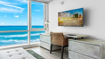 a room with a desk and a window with the ocean at Oceanview Private Condo at 1 Hotel & Homes -1120 in Miami Beach