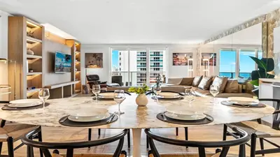 a dining room and living room with a table and chairs at Oceanview Private Condo at 1 Hotel & Homes -1120 in Miami Beach