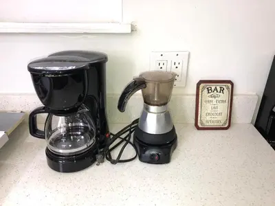 a blender sitting on a counter next to a clock at Spacious and Comfy Suite near MIA 2 Queen Beds in Miami