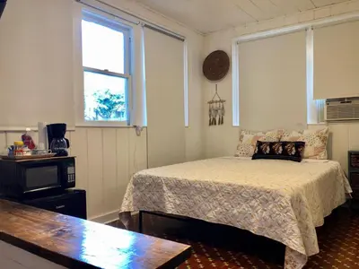 a bedroom with a bed and a clock on the wall at Private Studio with Free Parking in Miami