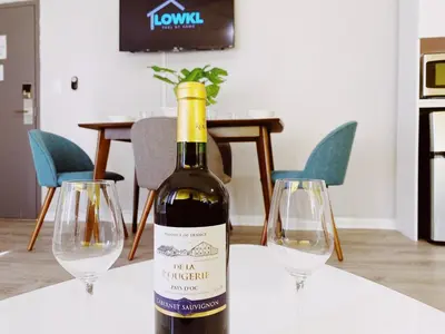 a bottle of wine on a table with two wine glasses at Miami International by Lowkl in Miami Beach