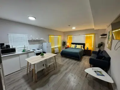 a small living room with a bed and a kitchen at Miami International by Lowkl in Miami Beach