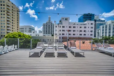 a row of benches on a boardwalk in a city at The Samantha by Lowkl in Miami Beach