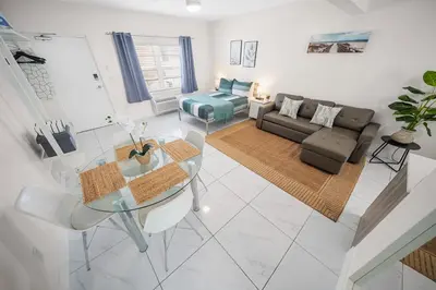 a living room with a glass table and a couch at The Samantha by Lowkl in Miami Beach