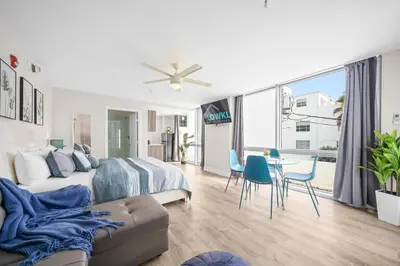 a bedroom with a bed and a table and chairs at The Samantha by Lowkl in Miami Beach