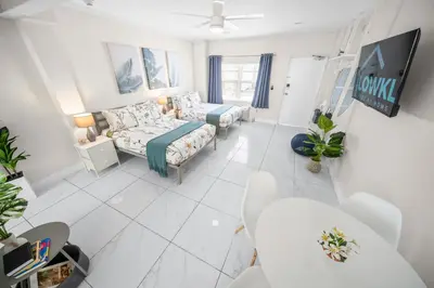 a living room with a bed and a couch at The Samantha by Lowkl in Miami Beach