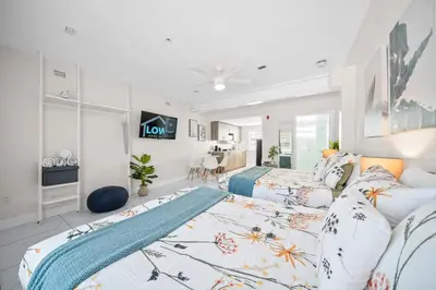 a bedroom with two beds and a living room at The Samantha by Lowkl in Miami Beach