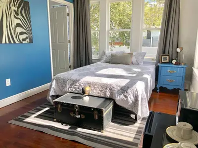 a bedroom with a bed with a trunk on a rug at Private Suite Mins from MIA Free Parking in Miami