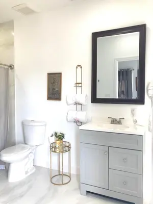 a bathroom with a sink and a toilet and a mirror at Private Suite Mins from MIA Free Parking in Miami