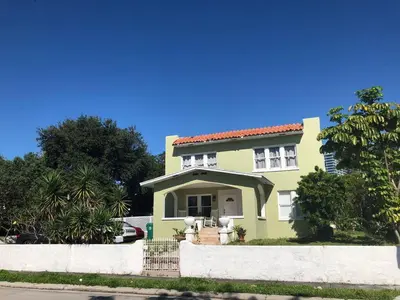 a yellow house with a red roof at Private Suite Mins from MIA Free Parking in Miami