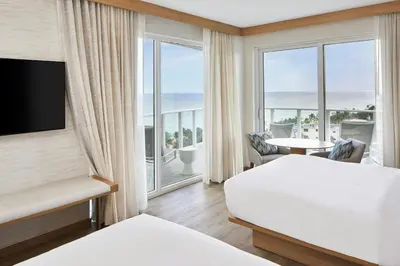 a hotel room with two beds and a view of the ocean at AC Hotel by Marriott Fort Lauderdale Beach in Fort Lauderdale