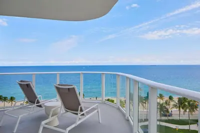 a balcony with two chairs and the ocean at AC Hotel by Marriott Fort Lauderdale Beach in Fort Lauderdale