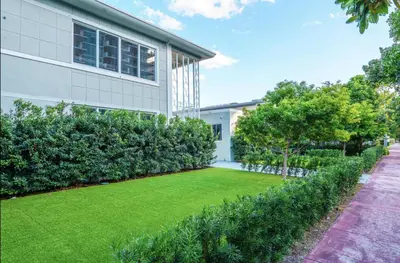 a house with a lawn in front of a building at Boutique Apartments Flamingo in Miami Beach