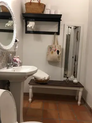 a bathroom with a sink and a toilet and a mirror at Private Loft in the Heart of Little Havana in Miami