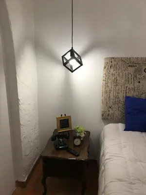a bedroom with a bed and a table with a laptop at Private Loft in the Heart of Little Havana in Miami