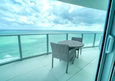 a table and chairs on a balcony with the ocean at Life Resort on Miami Hollywood BeachFront by MRA in Hollywood