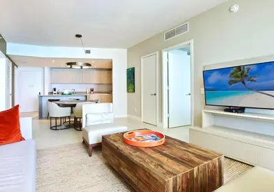 a living room with a coffee table and a television at Life Resort on Miami Hollywood BeachFront by MRA in Hollywood