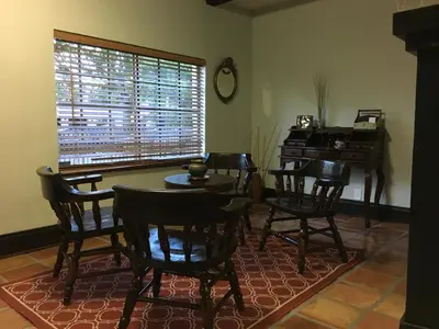 a dining room with a table and chairs and a piano at Heavenly Suite in Little Havana Free Parking in Miami