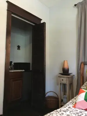 a bedroom with a wooden cabinet next to a bed at Private room in the Heart of Little Havana in Miami