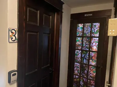 a door with a stained glass window next to it at Private room in the Heart of Little Havana in Miami