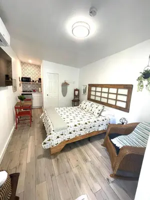 a bedroom with two beds and a table in it at Studio close to Everything in Miami