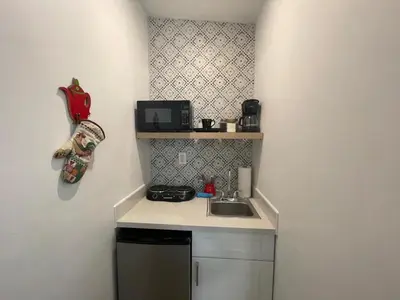 a small kitchen with a sink and a microwave at Studio close to Everything in Miami