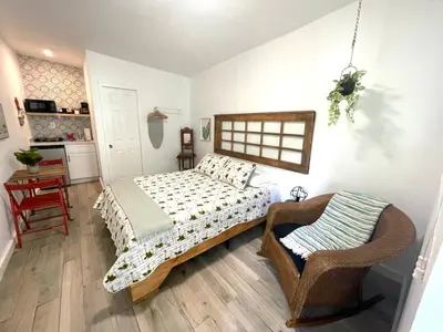 a bedroom with a bed and a chair at Studio close to Everything in Miami