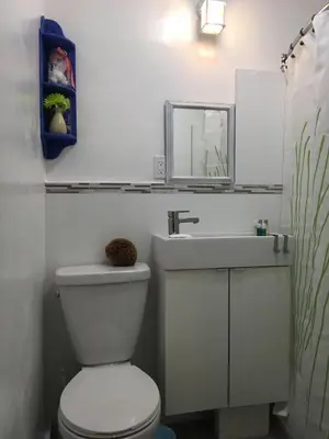a bathroom with a white toilet and a sink at Studio close to Everything in Miami