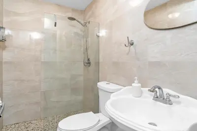 a bathroom with a toilet and a sink and a shower at Coral Suite close to Little Havana in Miami