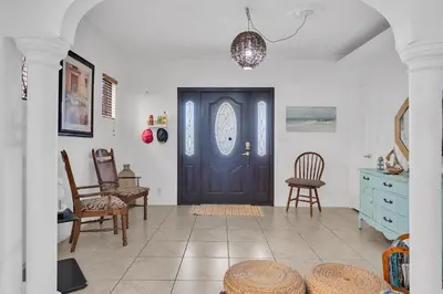 a room with a black door and some chairs at Private room in Little Havana in Miami