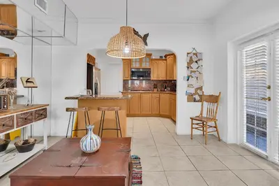a kitchen with wooden cabinets and a vase on a table at Private room in Little Havana in Miami