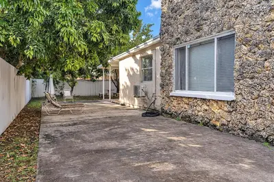 a house with a bench next to a building at Private Studio in Little Havana in Miami