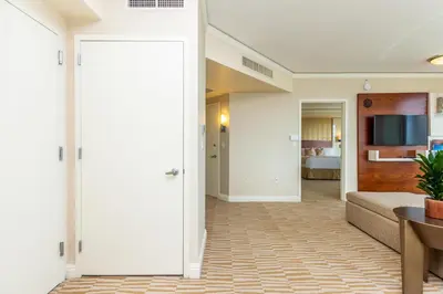 a living room with a couch and a television at Trump International Beach Resort Ocean View 1100 sf 1 Bed 1Bth Privately Owned Sunny Isles in Miami Beach