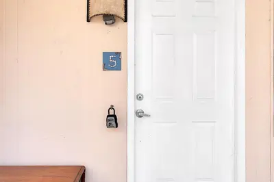 a white door with a dollar sign on it at Boho Studio in Little Havana in Miami