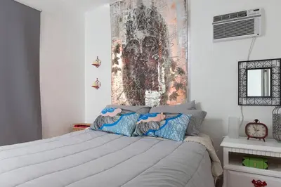 a bedroom with a bed with a painting on the wall at 1 Bedroom Apt near Coconut Grove in Miami