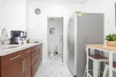 a kitchen with a refrigerator and a toilet in it at Girasole Suites in Miami Beach