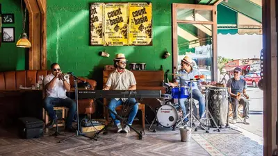 a group of people playing music on the street at Cozy Room in the Heart of Little Havana in Miami