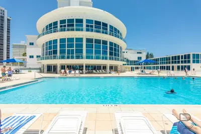 a swimming pool in front of a building at Girasole Rentals in Miami Beach