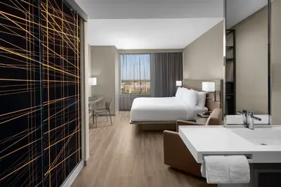 a hotel room with a bed and a bathroom at AC Hotel by Marriott Miami Dadeland in Miami