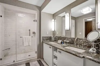 a bathroom with two sinks and a shower at Coastal studio w hot tub gym access in Fort Lauderdale