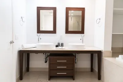 a bathroom with two sinks and two mirrors at Icon Brickell Miami in Miami
