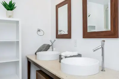 a bathroom with two sinks and two mirrors at Icon Brickell Miami in Miami