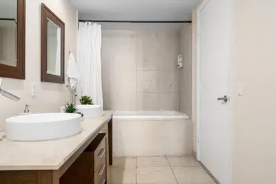 a bathroom with a sink and a tub and a shower at Icon Brickell Miami in Miami
